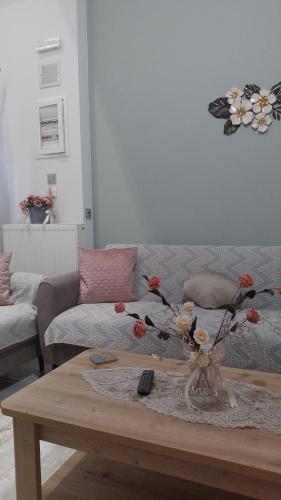 a living room with a couch and a coffee table at MiniLoft apartment in Volos