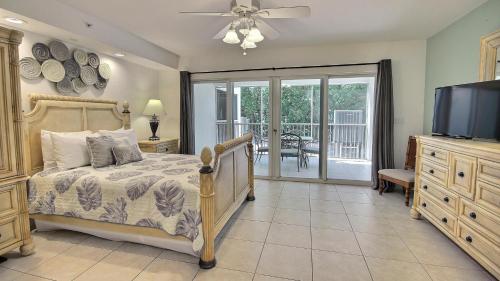 a bedroom with a bed and a flat screen tv at 609 Mariners Club in Key Largo