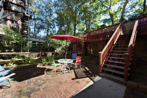 a patio with a table and an umbrella and stairs at Pvt Room, St Marys, Fenway, Longwood, Green Line in Brookline
