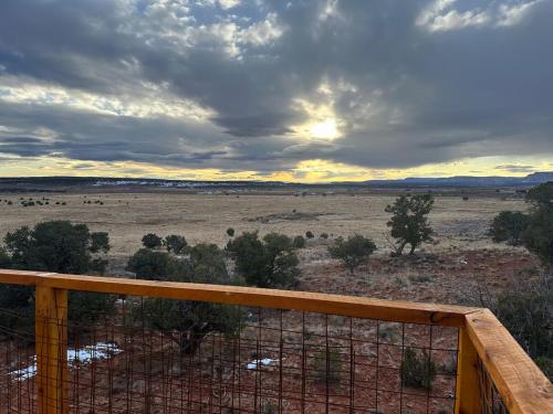 a view of a field from a wooden fence at Tiny Cabin #3 at The Cedars in Kanab