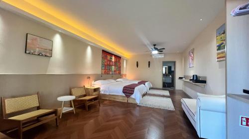 a hotel room with a bed and a living room at Rainbow&Resort in Nadi