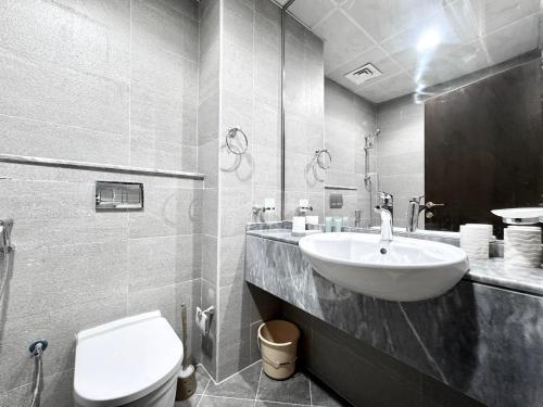 a bathroom with a sink and a toilet at Al Manara Classic Cozy Studio in Dubai