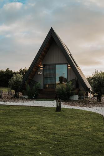 a small house with a gambrel roof at The Cove Tasmania in Devonport