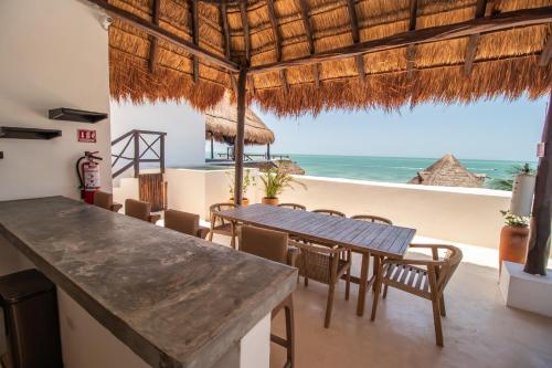 a dining room with a view of the ocean at HAU Holbox, Oceanfront Boutique Hotel in Holbox Island
