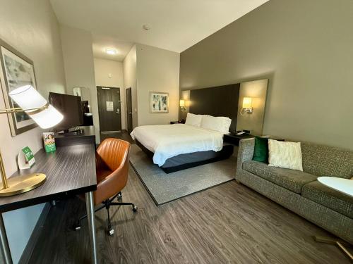 a hotel room with a bed and a couch at Holiday Inn Carlsbad/San Diego by IHG in Carlsbad