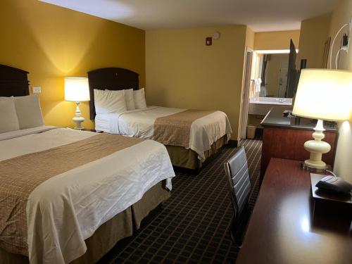 a hotel room with two beds and two lamps at Travelinn in Unadilla