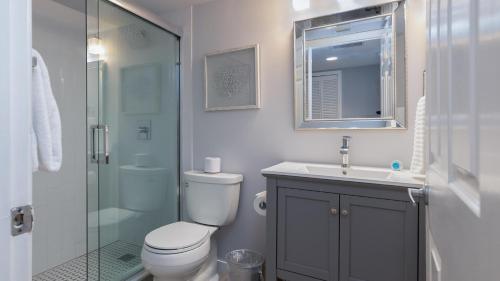 a bathroom with a toilet and a sink and a shower at 610 Mariners Club in Key Largo