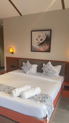 a bedroom with two beds with white pillows at Ved Villa Netflix, Pool, Chill in Panchgani