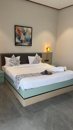 a bedroom with a large bed with a tray on it at Ved Villa Netflix, Pool, Chill in Panchgani