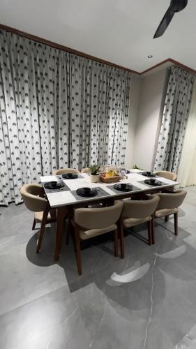 a dining room with a table and chairs at Ved Villa Netflix, Pool, Chill in Panchgani