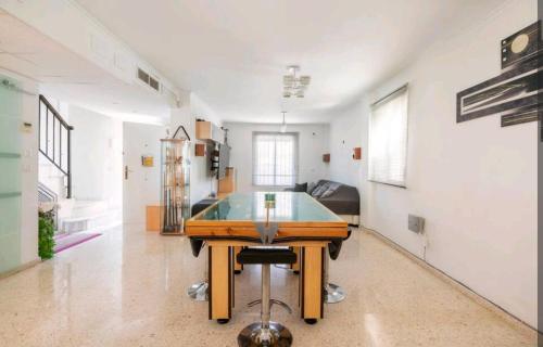 a living room with a ping pong table in it at Yosa in Alcalá del Río