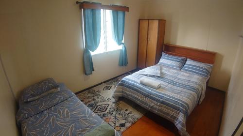 a bedroom with a bed and a window at Shalom Mission Home in Mount Hagen