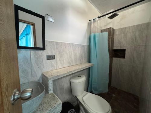 a bathroom with a toilet and a sink and a shower at BYMAR Resort in Necoclí