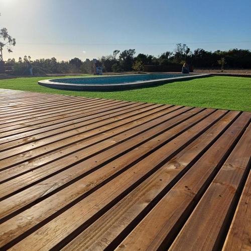 a wooden bench in a park with a field of grass at Domo Tunquen in Tunquen