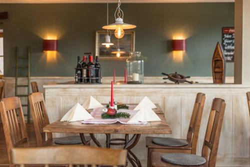a dining room table with a candle on top of it at Gasthof Chiemseefischer in Grabenstätt
