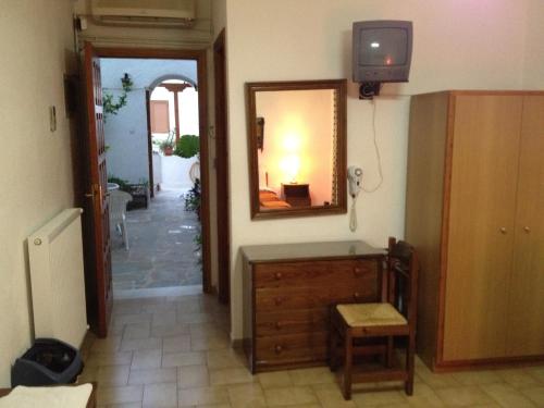 a hallway with a mirror and a dresser in a room at Pantazis Studios in Aegina Town