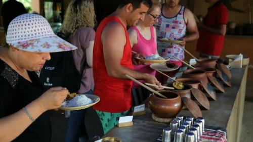 a group of people preparing food at a buffet at Nature's Nest Eco Resort Goa, Near Dudhsagar Waterfalls in Molem