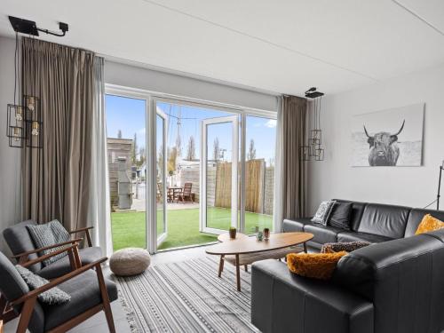 a living room with a couch and a table at Waterfront Holiday Home with Terrace & Views in Stavoren