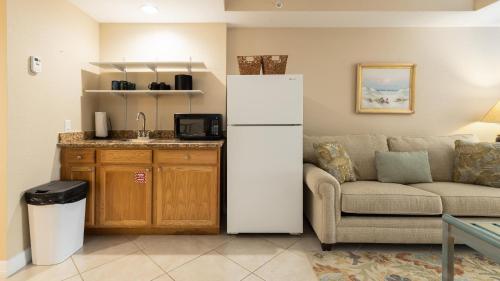 a living room with a refrigerator and a couch at 611 Mariners Club in Key Largo
