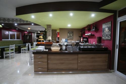 a restaurant with a counter in the middle of a room at Hotel Villa Nadin in Mostar