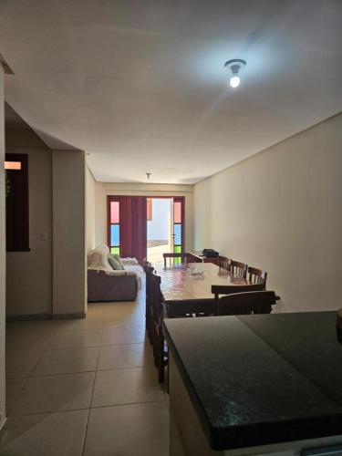 a living room with a table and a couch at Casa em Lençóis in Lençóis