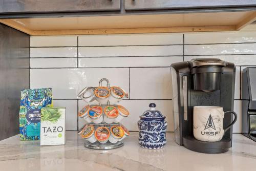 a counter top with a coffee maker and vases on it at 34 Acre Escape Games Hiking Pool Table Bicycles in Black Hawk