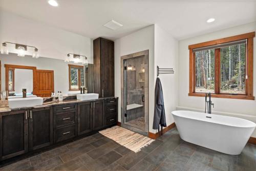 a bathroom with two sinks and a tub and a shower at 34 Acre Escape Games Hiking Pool Table Bicycles in Black Hawk