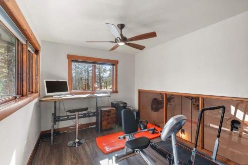 a room with a gym with a desk and a computer at 34 Acre Escape Games Hiking Pool Table Bicycles in Black Hawk