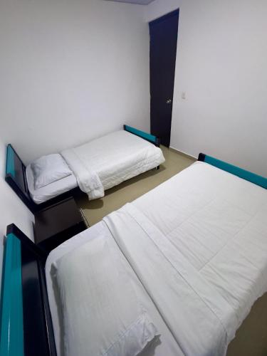 a room with two beds in a room at Hotel Blue in Santa Rosa de Cabal