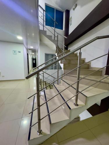 a staircase in a building with a metal railing at Hotel Blue in Santa Rosa de Cabal
