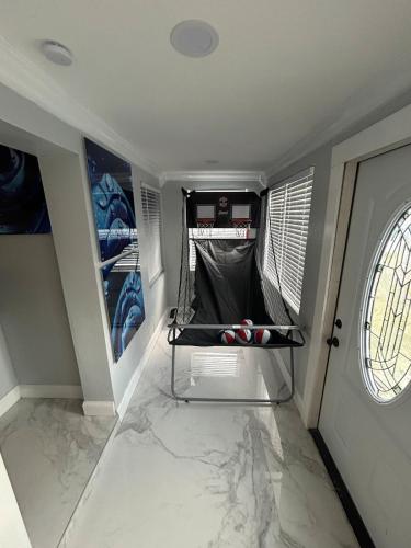 a room with a white marble floor and a room with a window at Luxury Entertainment home Hard rock stadium in Opa-locka