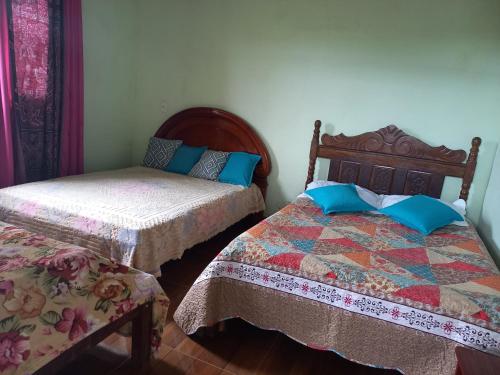 a bedroom with two beds and a bedskirts at Sitio trem bao demais in Mateus Leme
