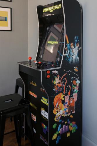 a video game machine with a bunch of stickers on it at Near Hershey, Entire house with Fire Pit, Game Room in Middletown