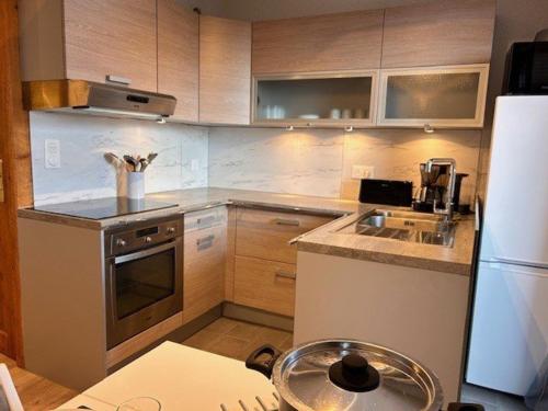 une petite cuisine avec un évier et un réfrigérateur dans l'établissement Studio confortable à Risoul, proche pistes et commerces - FR-1-330-548, à Risoul