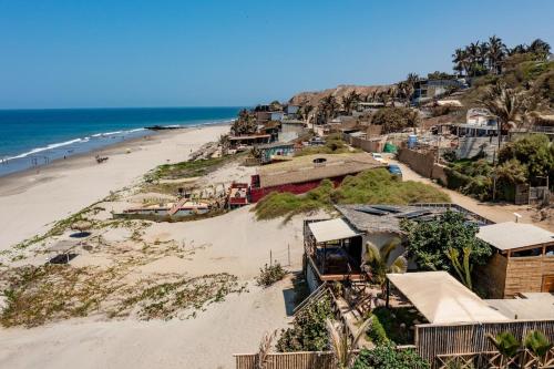 a view of a beach with houses and the ocean at Private Complete Beach House, POOL AC, Vichayito in Vichayito