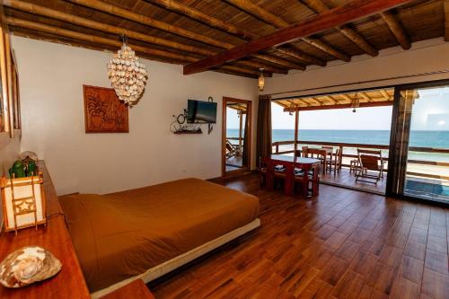 a bedroom with a bed and a view of the ocean at Private Complete Beach House, POOL AC, Vichayito in Vichayito