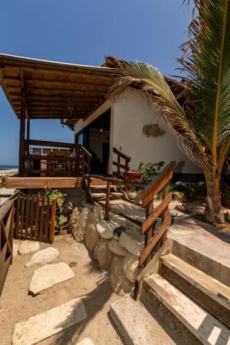 a house on the beach with a palm tree at Private Complete Beach House, POOL AC, Vichayito in Vichayito