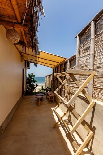 a couple of chairs sitting on the side of a building at Private Complete Beach House, POOL AC, Vichayito in Vichayito