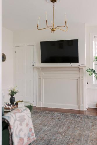 a living room with a tv above a fireplace at Near Hershey, Entire house with Fire Pit, Game Room in Middletown