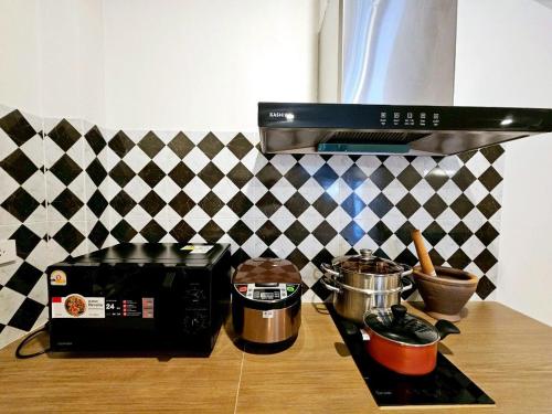 a kitchen counter with a toaster oven and pots and pans at Medina Private Pool Villa-บางแสน in Ban Puk (1)