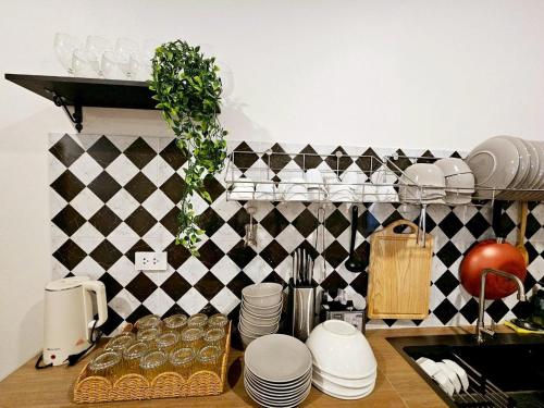 a kitchen counter with plates and dishes on a shelf at Medina Private Pool Villa-บางแสน in Ban Puk (1)