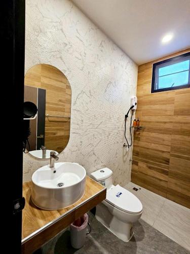 a bathroom with a sink and a toilet and a mirror at Medina Private Pool Villa-บางแสน in Ban Puk (1)