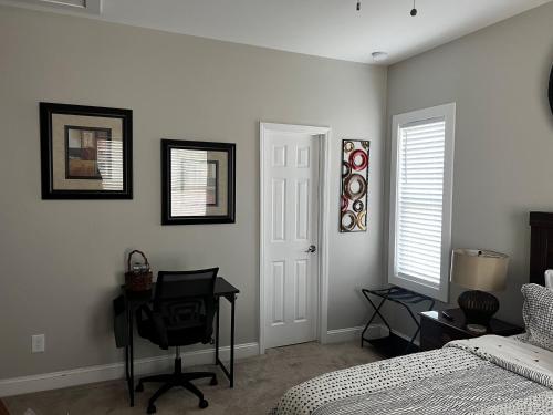 a bedroom with a bed and a desk and a desk at The Bungalow in Charlotte
