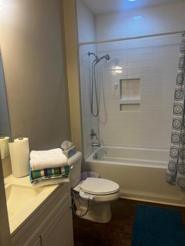 a bathroom with a white toilet and a shower at The Bungalow in Charlotte