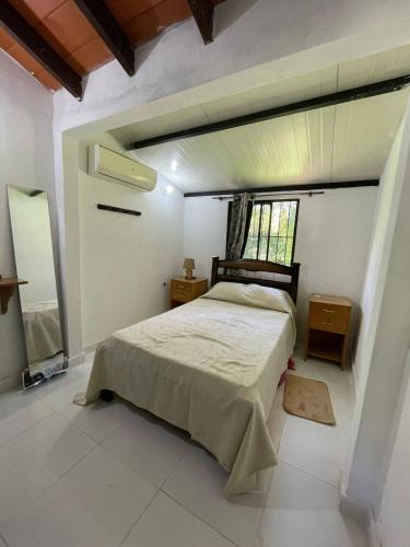 a bedroom with a bed and a window in it at El Cedro in San Bernardino