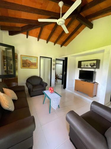 a living room with couches and a ceiling fan at El Cedro in San Bernardino