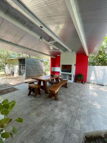 a patio with picnic tables and red walls at El Cedro in San Bernardino