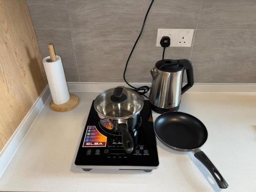 a kitchen counter with a tea kettle and a blender at Shah Alam Homestay 4BDR by StayScape in Shah Alam