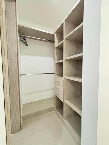 a walk in closet with wooden shelves at Casa Di Mare in Santa Veronica