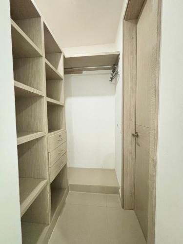 a walk in closet with wooden shelves and a door at Casa Di Mare in Santa Veronica